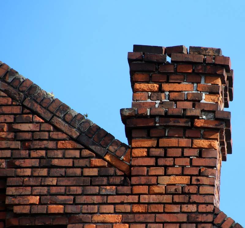 Signs Your Dover Home Needs a Chimney Inspection Damaged chimney on an Dover home showing cracks and missing mortar